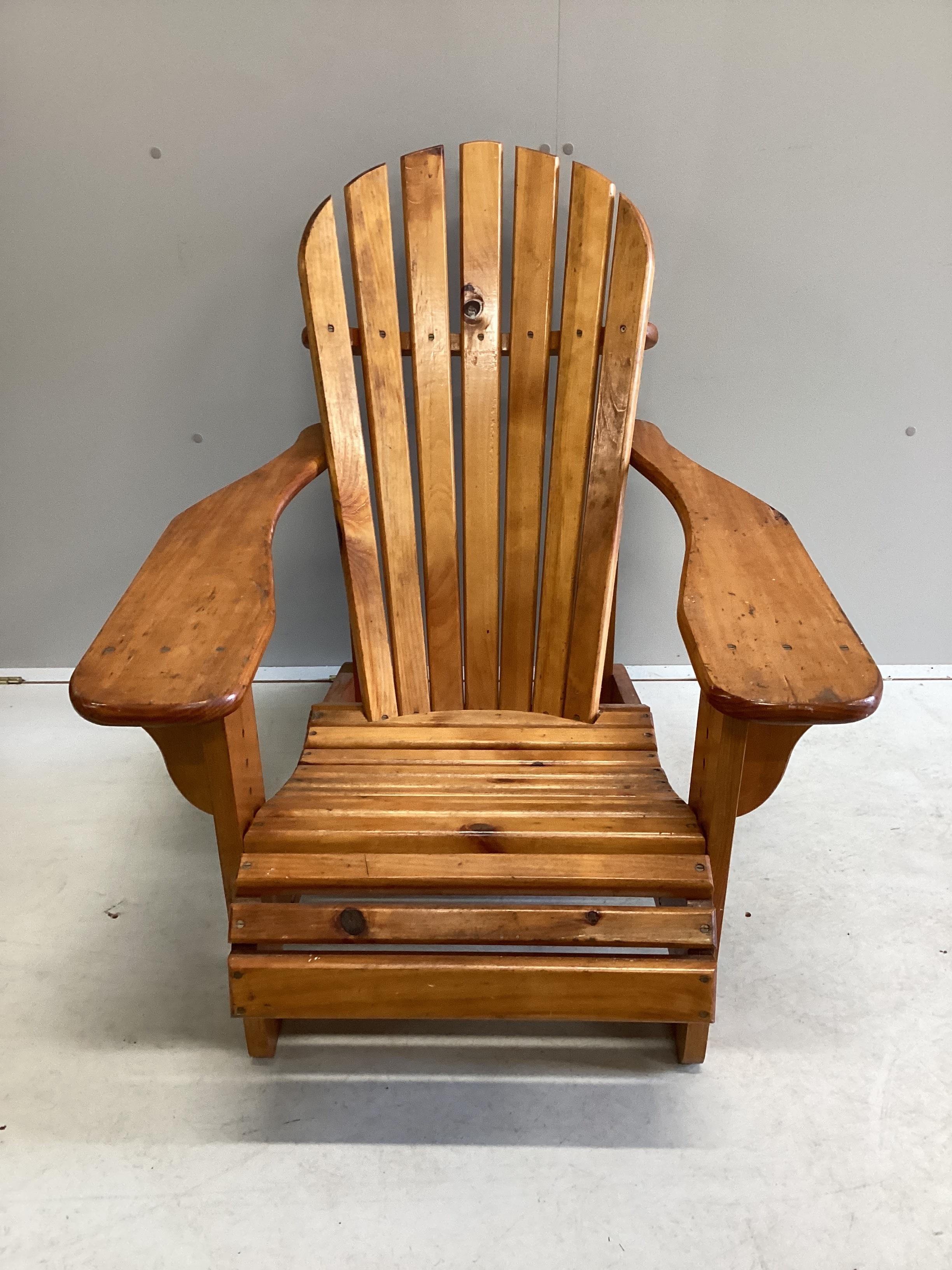 A stained pine Adirondack garden chair, width 78cm, depth 98cm, height 90cm